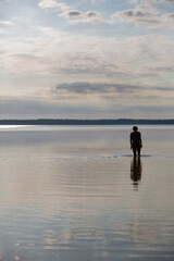Fototapeta na wymiar Silhouette of a woman going to swim in the lake