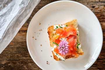 sandwich with chives butter, chives, salmon. Wooden background, top view
