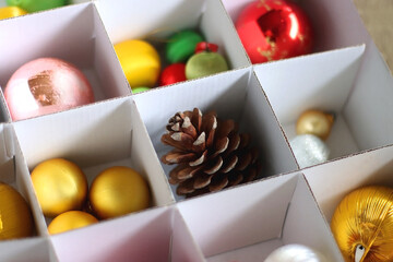 Boxes with various organized Christmas ornaments. Decorating or taking down the Christmas tree....