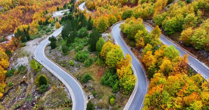 Majestic autumnal view of a Thethi national park in Albania and the mountain road passing through it. 