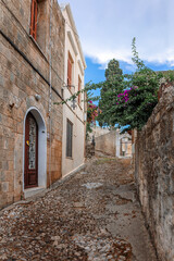 Fototapeta na wymiar Street view of old town of Rhodes, Greece. Paved roads and pavements with colorful houses and fragrant flowers. High quality photo