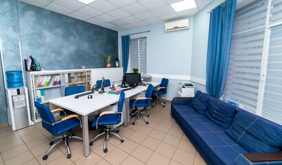 Modern blue office with sofa. Comfortable office interior decoration.