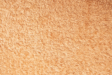 Detailed texture of fluffy peach textile towel surface