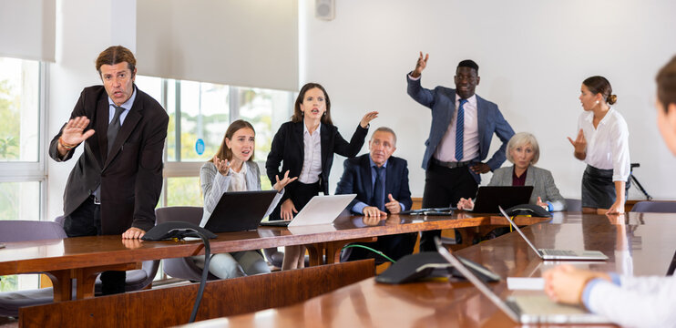 Group of diverse business persons having quarrel in conference room.