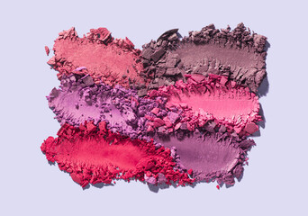 Make-up eye shadow texture purple fuchsia red smudge swatches isolated on gray background