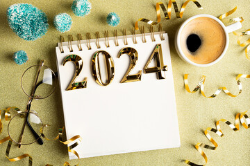 2024 New year resolutions on desk. 2024 goals list with notebook, coffee cup, festive decorations...