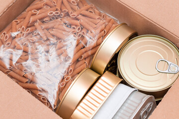 Food Reserves or Donation Box: Carton Box with Canned Food, Cereals and Grocery. Emergency Food Storage in Case of Crisis. Free Social Help, Blessings and Care. Strategic Food Supplies