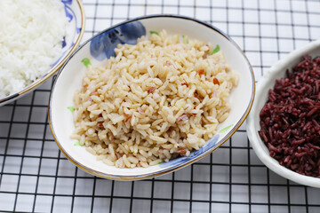 Cooked white, brown, black rice in bowl
