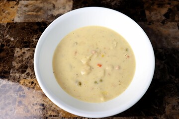 a bowl that is on a table with the soup in it