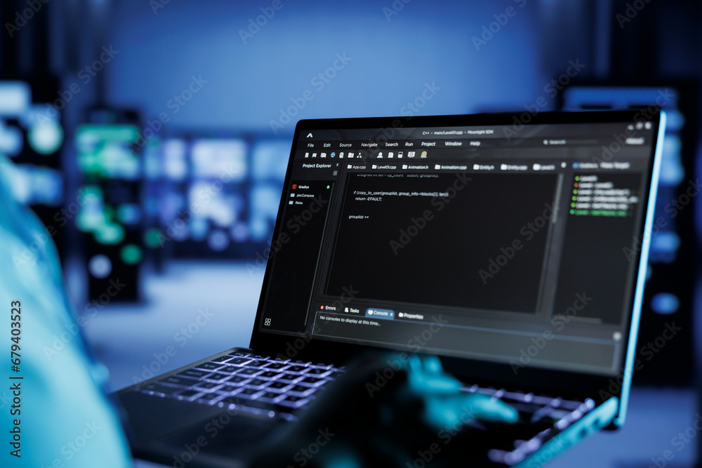 Poster certified technician running code and programming on laptop, troubleshooting and upgrading high tech