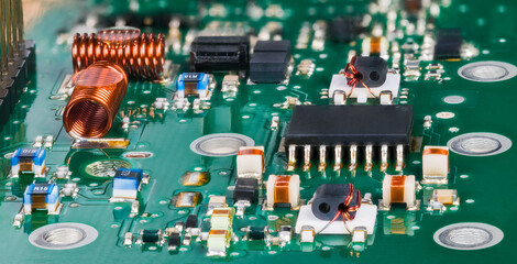 Closeup of surface mounted electronic components in radio-frequency circuits of TV tuner....