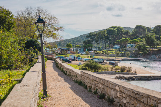 Osor and its famous narrow passage of water with a water bridge. Parking space close to the canal and a sole electric lantern on a path