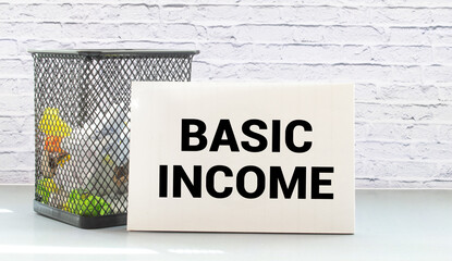 clipboard with white blank paper text BASIC INCOME , keyboard calculator and chart, business concept.