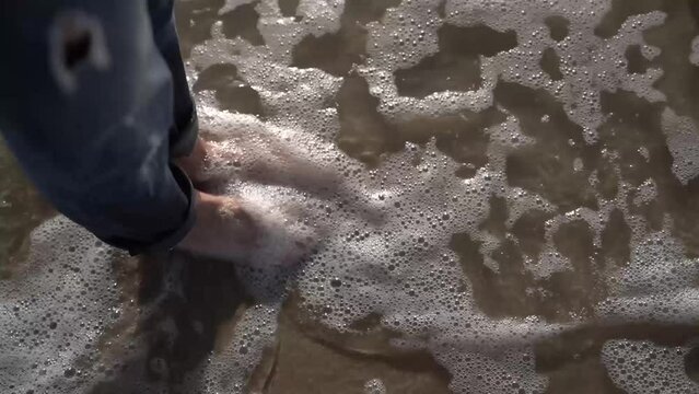 a girl walks barefoot on the sea