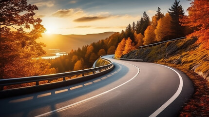 Curved road on autumn, beautiful curved pass with vehicles and colorful autumn nature colors on trees with sunset light. - obrazy, fototapety, plakaty