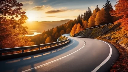 Fotobehang Curved road on autumn, beautiful curved pass with vehicles and colorful autumn nature colors on trees with sunset light. © Santy Hong