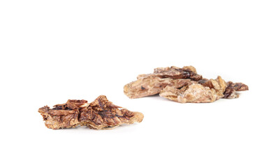 Dried beef lung dog treats. Air dried or dehydrated cattle beef lung with defocused pile. Single protein ingredient rich on vitamins and minerals with soft texture. Selective focus. White background