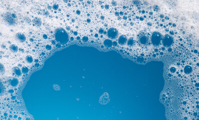 Detergent foam bubble on wate. Blue background, Soap sud