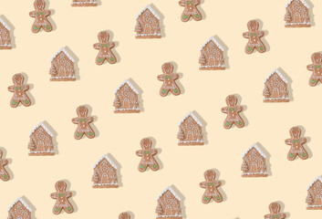 Trendy pattern made of gingerbread Christmas tree decoration on pastel beige background. New Year party background. Minimal style. Creative Christmas or New Year concept. Winter holidays idea.