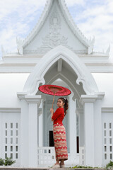 Beautiful Burmese girl  hold red umbrelar walk in temple