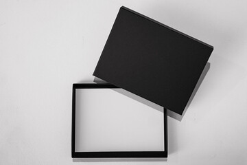 top view of an empty black voucher gift box with white paper placeholder as mockup for black friday...