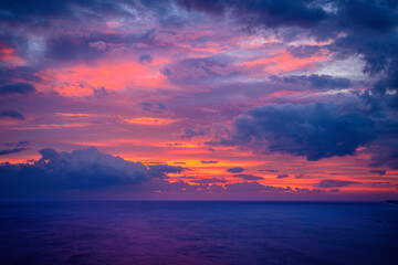 Sunrise Seascape at the East Sea in Korea, dramatic cloudscape and vibrant pink sun rays over the...