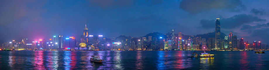 Panorama of Hong Kong skyline cityscape downtown skyscrapers over Victoria Harbour in the evening...