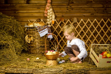 Easter fairy tale, a boy with chickens playing in a barn. beautiful Russian costumes and young chicks hatched from eggs.