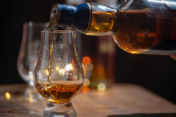 Glasses of single malt and blended scotch whisky served in bar in Edinburgh, Scotland, UK with...