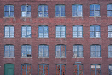 facade view of old factory building with red brick wall