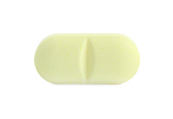 One yellow pill isolated on white. Medicinal treatment
