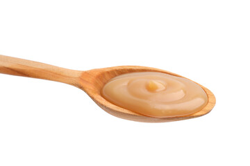 Wooden spoon with tasty salted caramel isolated on white