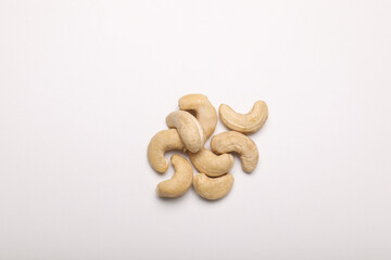 Many tasty cashew nuts on white background, top view