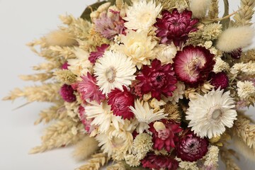 Beautiful bouquet of dry flowers on white background, closeup