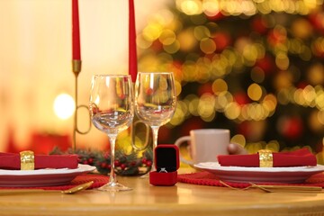 Naklejka na ściany i meble Making proposal. Christmas table setting and engagement ring indoors