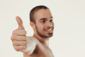 Cheerful man shows thumbs-up, clearly pleased