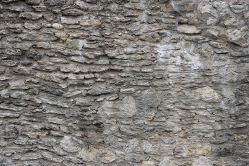 Very old brick stone wall of castle or fortress of 18th century. Full frame wall with obsolete dirty and cracked bricks close up