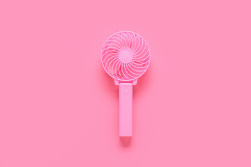Modern manual fan on pink background