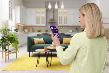 Woman using smart home control system via application on mobile phone indoors