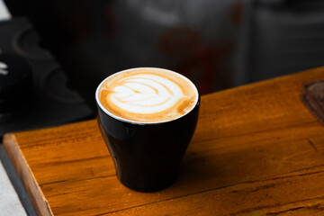 a cup of latte art in a coffee shop. 