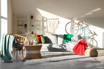 Interior of living room with Italian flag on sofa and bicycle