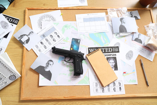 Table with clues of FBI agent in office, top view