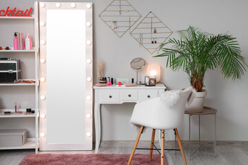 Interior of makeup room with glowing mirror and dressing table