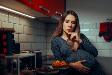 Hungry Pregnant Woman Thinking about having Muffins. Mother to be craving some sweet treats late in the evening
