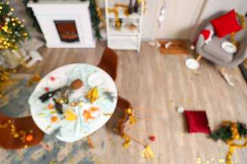Blurred view of messy living room after New Year party, top view