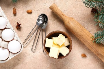 Different ingredients and rolling pin for preparing Christmas pie on beige background