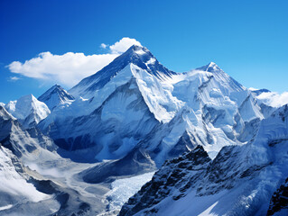 A mountain range covered in snow under a blue sky