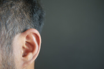 closeup of human ear on black background 