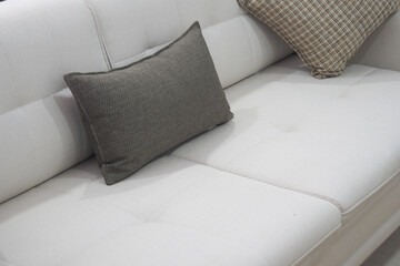 modern sofa with pillows in living room at home