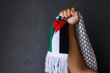 Freedom for Palestine. Hand grabbing Palestine scarf. 